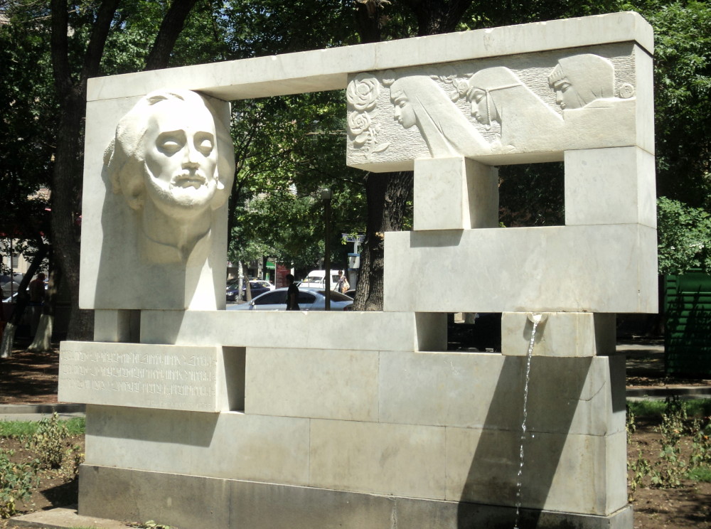 A Soviet-era fountain monument to Sayat Nova in Yerevan, next to a music school named after him, featuring the bard facing three young ladies, each representing one of the South Caucasus nations